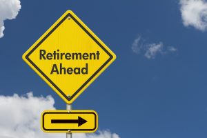 Retirement Ahead message on yellow warning road sign with sky. Concept of copier retirement.