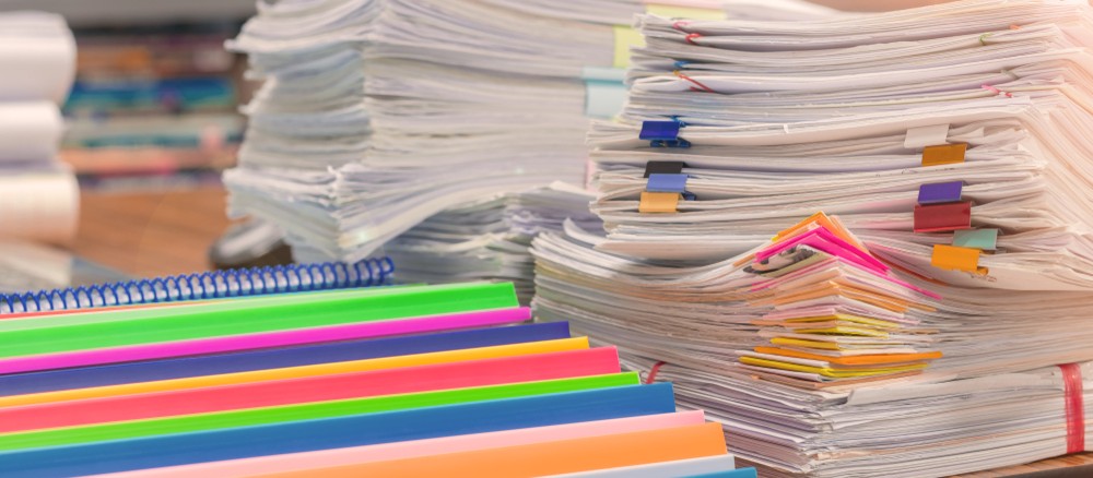 piles of papers on a school desk